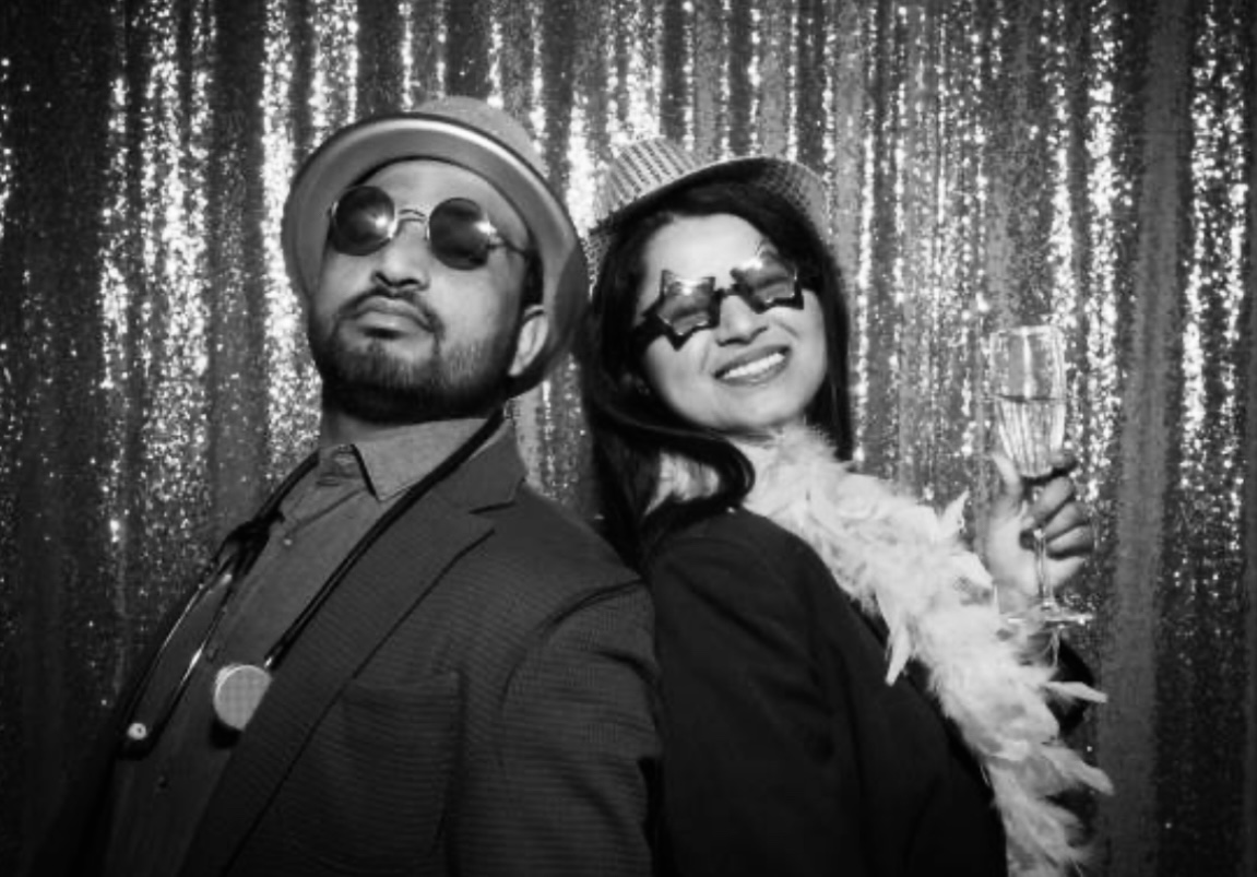 Elegant couple at formal event with sparkly backdrop