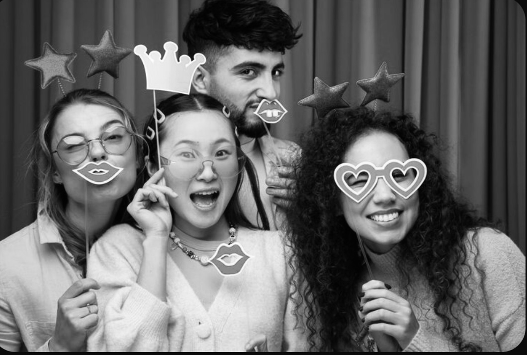 Group of friends with fun photo booth props and star headbands